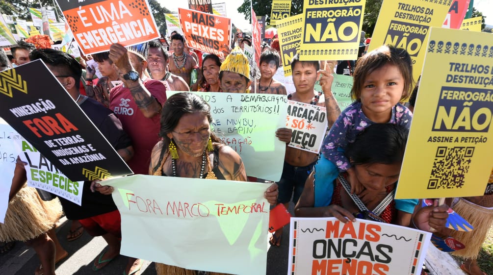 Indigenous people protesting with numerous placards