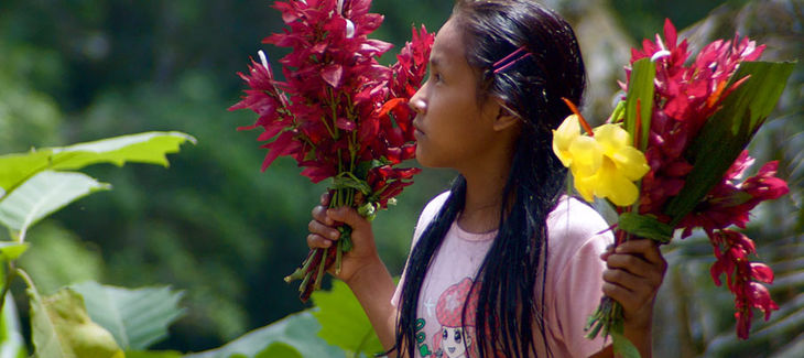 Kichwa girl with flowers in her hand in Sarayaku