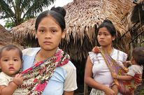 Two indigenous women with their children look worried