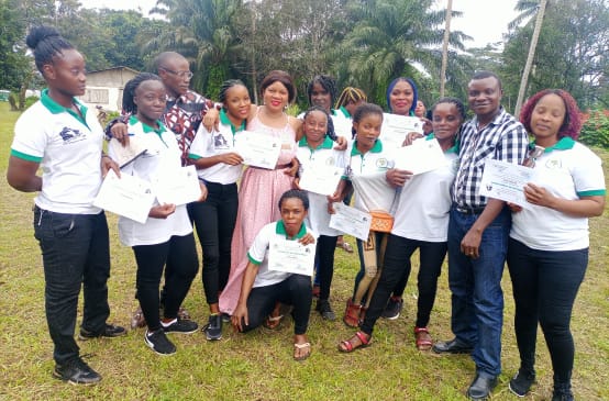 Ten women who learned to read, write and do basic math in a WCF project present their certificates