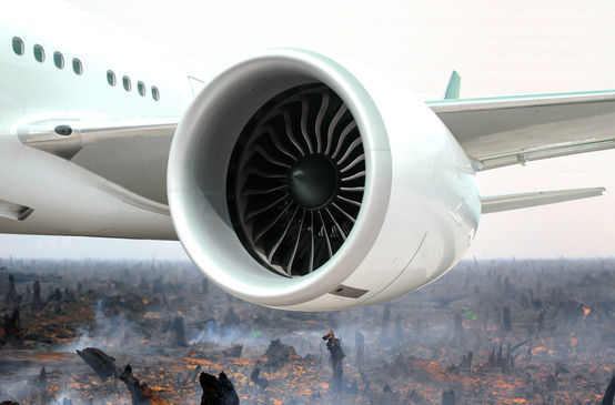 Photomontage: an aircraft engine in front of a torched rainforest
