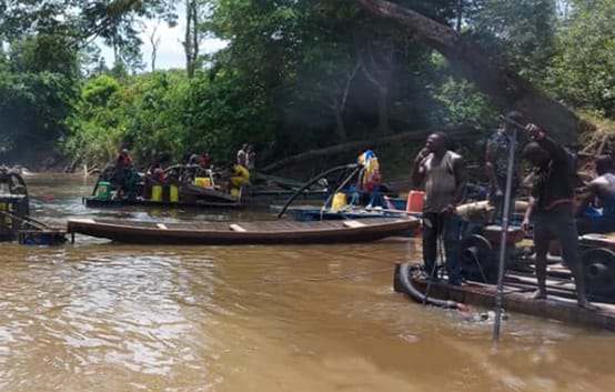 Gold prospectors on a river in Côte d’Ivoire