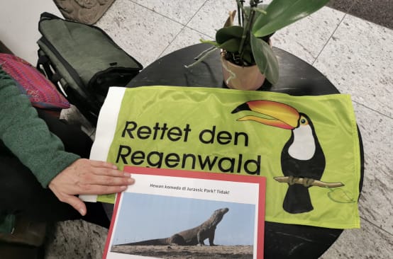 Rainforest Rescue banner and Komodo petition on a round table