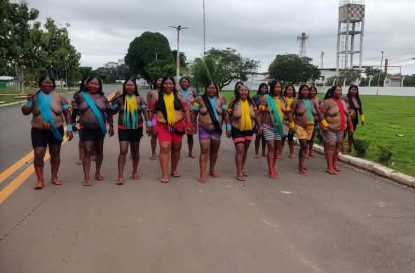 Twenty Indigenous women blocking a road