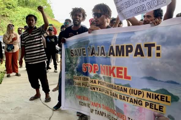 Protesters with banner “Save Raja Ampat: Stop Nickel”
