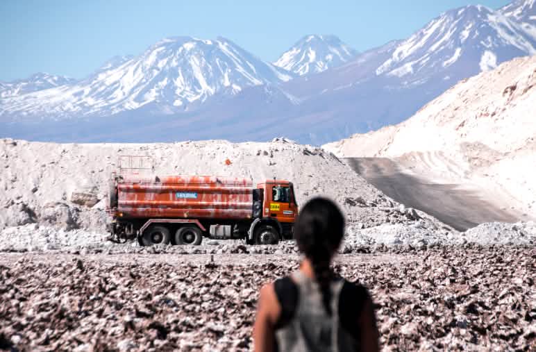 A woman looks at the lithium extraction in the Atacama salt flat, in the Andes mountain range, Chile