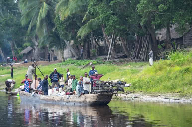A fully loaded pirogue is underway on the Congo River