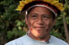 Portrait of indigenous leader Sarapo Ka'apor wearing a feather headdress