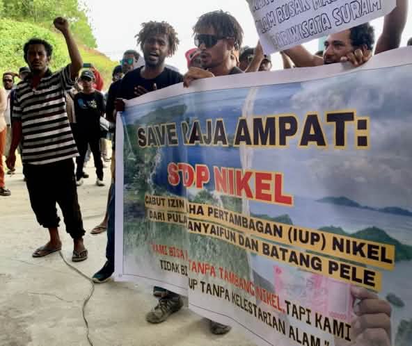 Protesters with banner “Save Raja Ampat: Stop Nickel”