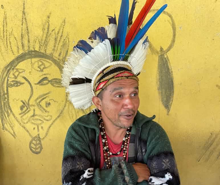 Portrait of Pataxó chief Mãdy wearing a feather headdress