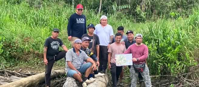 Indigenous Sungai Seruas people display a map they and SADIA produced