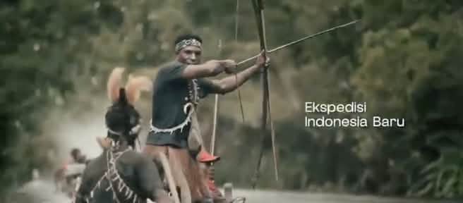 Papuans in a small boat armed with a bow and arrows