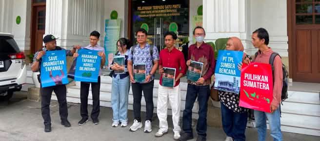Eight activists in front of a courthouse