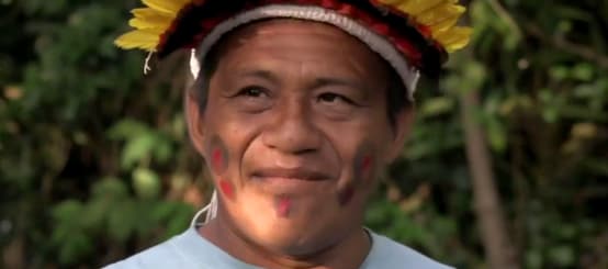 Portrait of indigenous leader Sarapo Ka'apor wearing a feather headdress