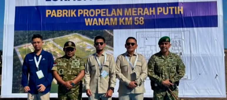 Five representatives of the government, military, and arms company in front of a billboard