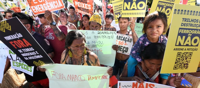 Indigenous people protesting with numerous placards