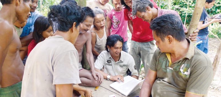 Activist Feri Irawan and indigenous Suku Anak Dalam people Indigenous Suku Anak Dalam with Feri Irawan in Jambi, Sumatra