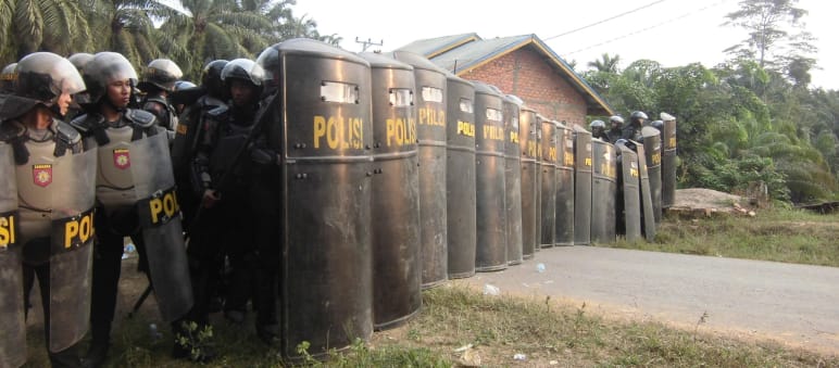 What is the greater threat to a peaceful society – indigenous people or the palm oil industry? Indonesia: police securing oil palm plantation