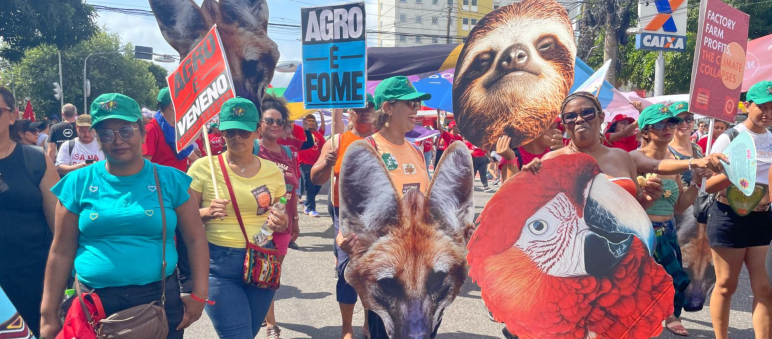Demonstrators in a street carrying placards with pictures of animals