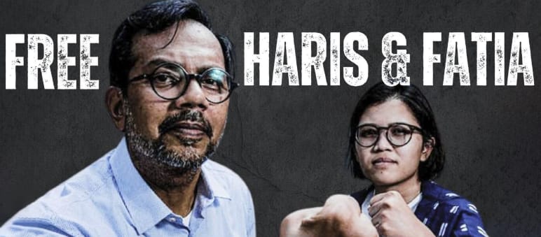 Haris Azhar and Fatia Maulidiyanti before a black background