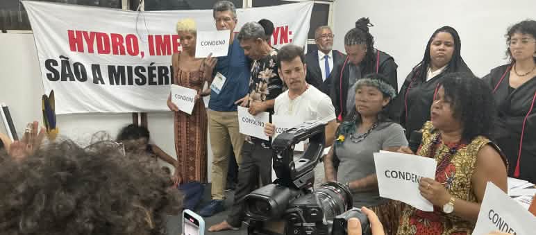 A group of ten people who conducted the symbolic trial are filmed with a camera and cell phones