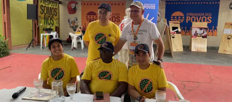 Group photo of five people behind a podium table