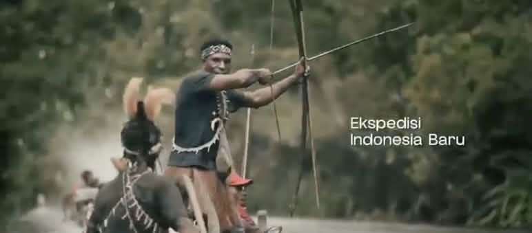Papuans in a small boat armed with a bow and arrows