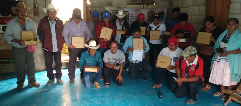 A group of people holding boxes containing radio equipment