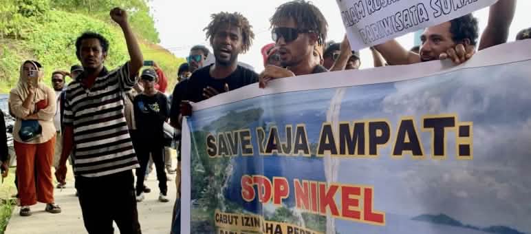 Protesters with banner “Save Raja Ampat: Stop Nickel”