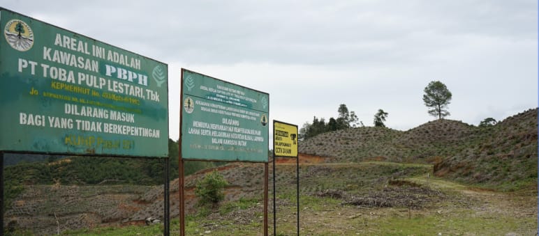 “No trespassing” signs in front of bare hills