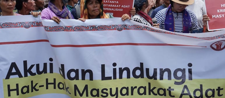 Banner reading “Honor and protect Indigenous rights”