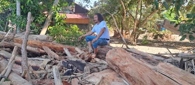 Yusmadi in the ruins of the AWF office