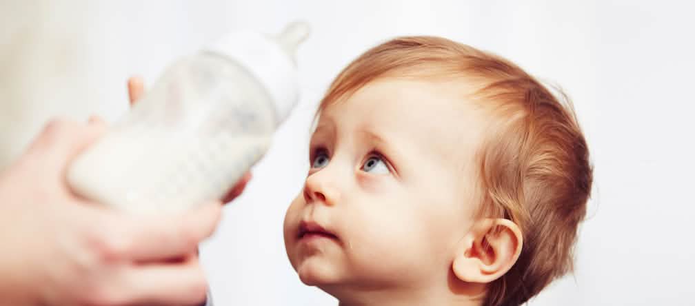 Children are particularly vulnerable to glycidol, a contaminant contained in processed palm oil. A worried-looking baby pushing its bottle away