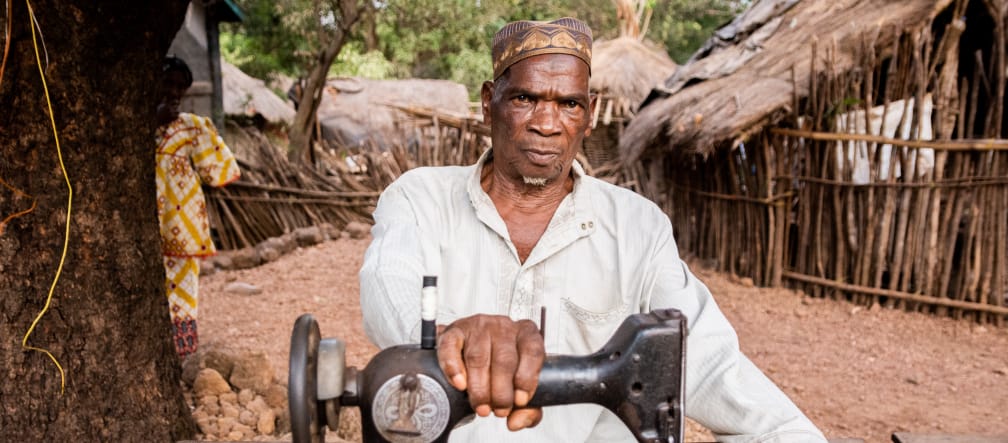 The village of Hamdallaye was razed for the Sangaredi bauxite mine. Tailor in Hamdallaye, Guinea