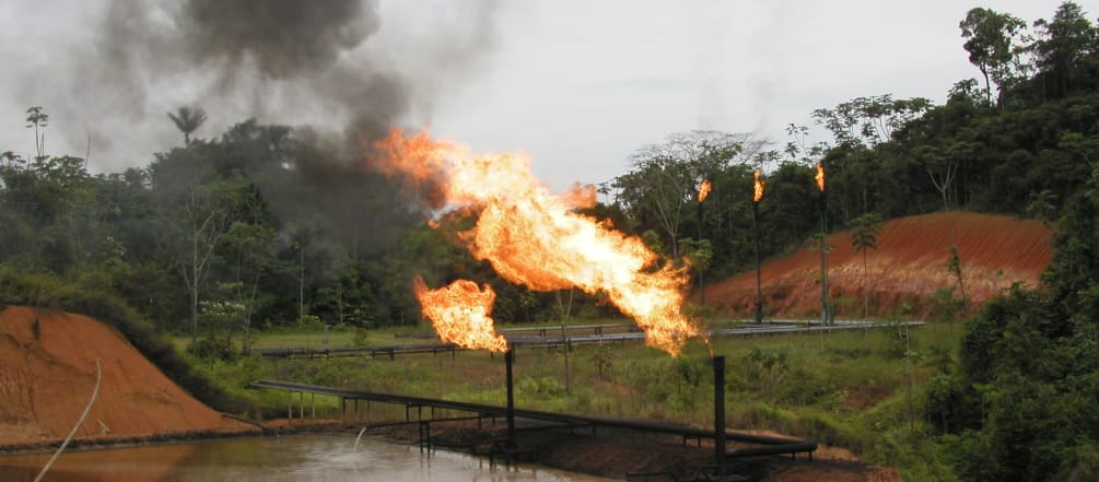 Gas flaring, pipelines and oil ponds in the rainforest