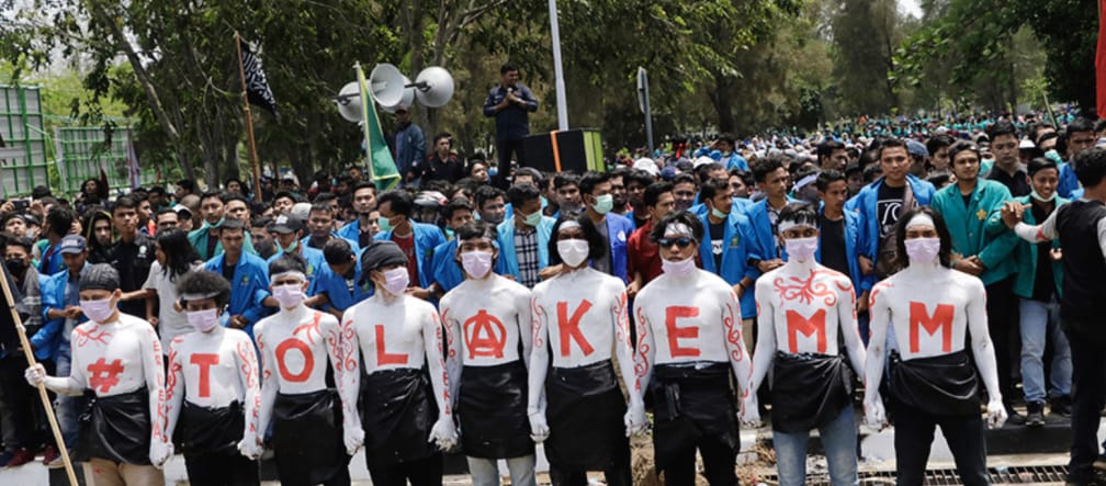NO to EMM in capital letters on the shirts of nine protesters