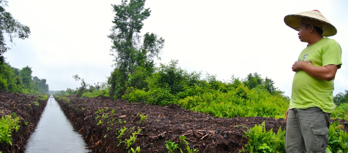 Matek Geram standing near a drainage ditch