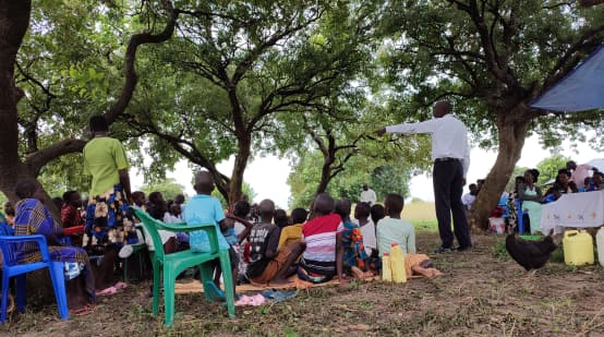 A TASHA field officer talks about the dangers of oil projects in a village