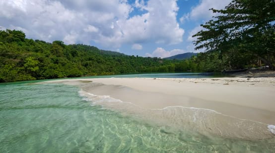 Waves wash over a beach on Koh Kong Island, Cambodia