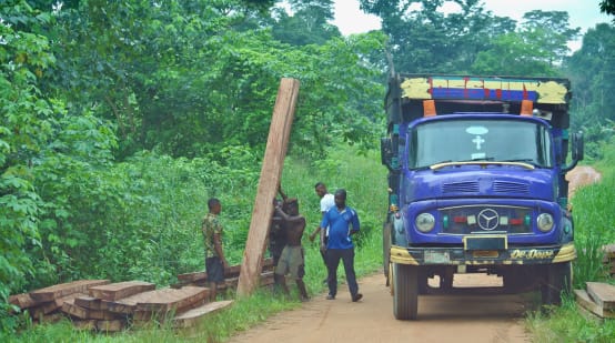 Men loading timber onto a truck