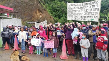 People protesting against mining with banners and posters