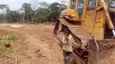 Boy in front of a bulldozer