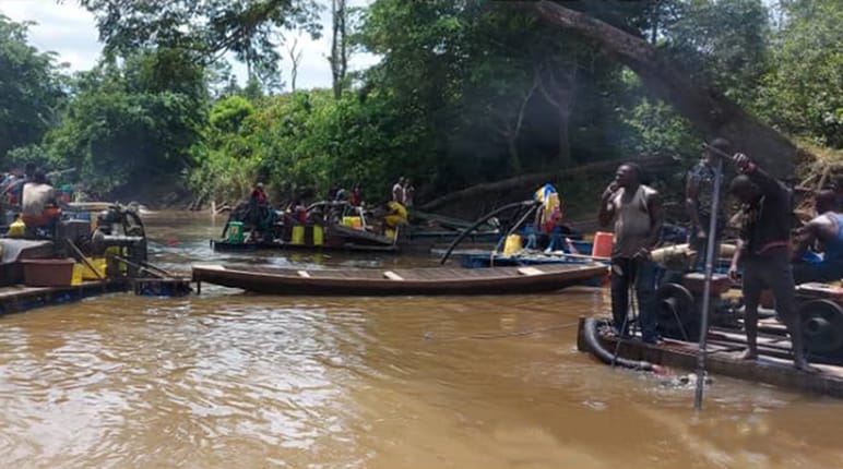 Gold prospectors on a river in Côte d’Ivoire