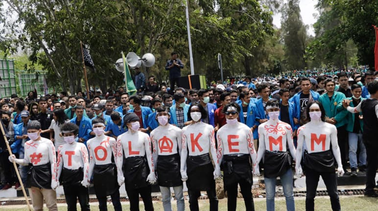 NO to EMM in capital letters on the shirts of nine protesters