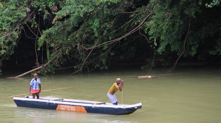 Two people canoeing on the river