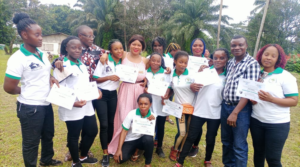 Ten women who learned to read, write and do basic math in a WCF project present their certificates