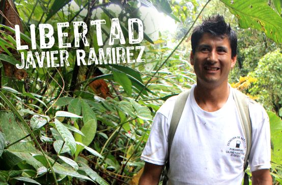 Javier Ramírez standing in front of rainforest plants