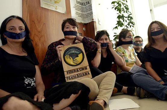 Activists with a taped mouth in Quito