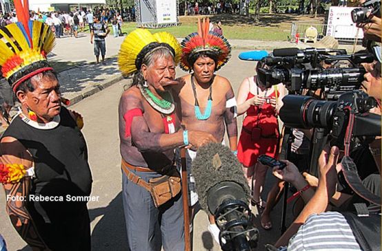 Chief Raoni with his feathered headdress and war paint gives an Interview
