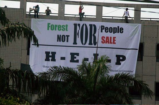 Protesters hanging up a banner: forest for people, not for sale